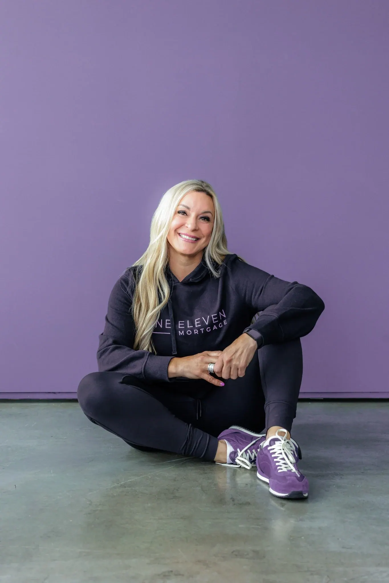 Kahren in her One Eleven sweatshirt and purple sneakers