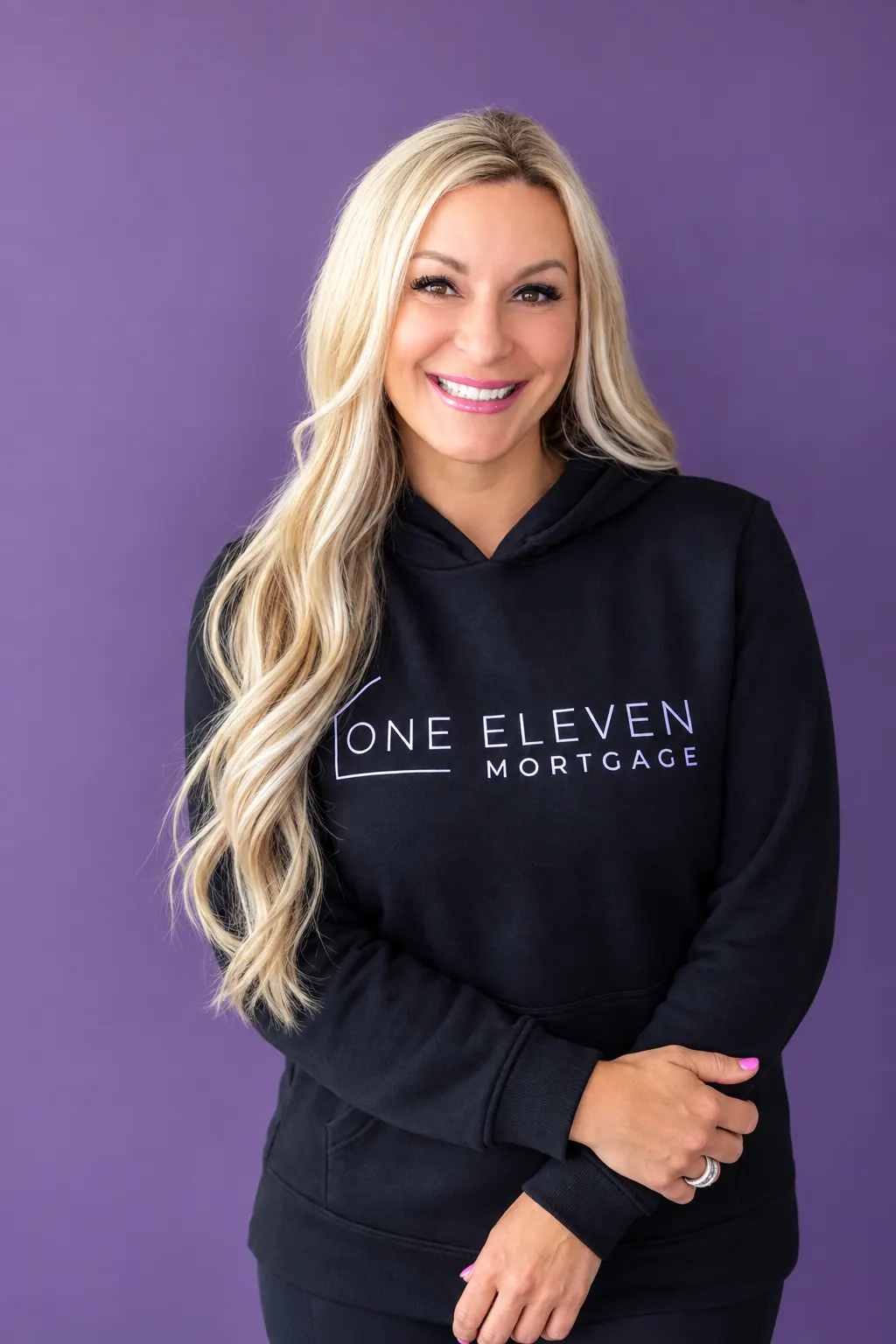 Kahren Oxner in a One Eleven Mortgage hoodie against a purple background